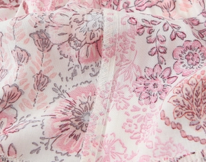 Macro view of floral print fabric with fine stitching on a casual skirt