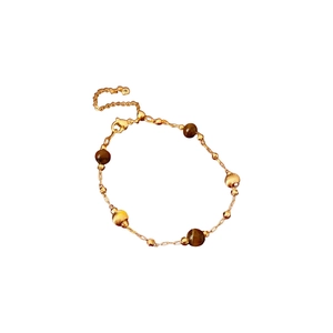 Gold-plated bracelet featuring brown tiger eye stones and textured metal pearls