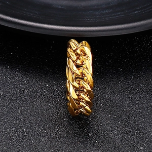 Macro shot of gold Cuban link chain ring in polished stainless steel for men