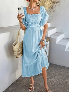 Detail of light blue bohemian dress showing square neck and ruched bodice details