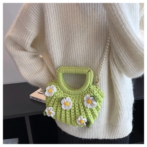Green handmade knit shell bag with white daisies and an elegant pearl shoulder strap