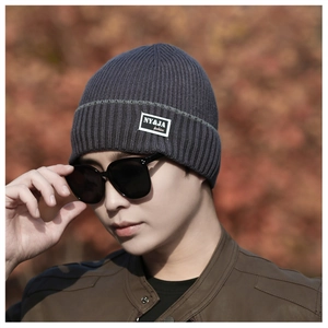Close-up of winter knit beanie showing thick ribbed texture and NY&JA fashion fabric label