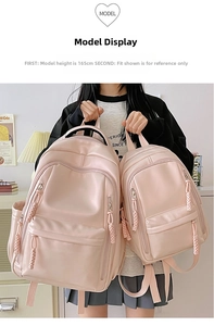 Detailed comparison of large and small pale pink water-resistant backpacks being held