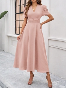 Detail of pink V-neck dress featuring short sleeves and a vertical striped fabric texture