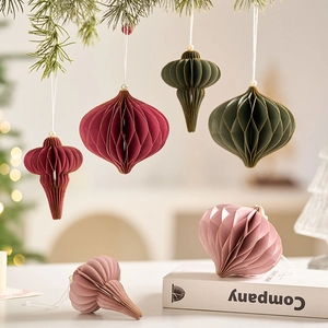 Nordic honeycomb paper Christmas ball ornaments in vintage colors on pine branches