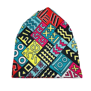 Detail of knit beanie featuring colorful retro Memphis geometric prints and textures