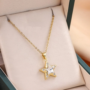 Elegant gold star pendant necklace with star-cut zircon in a green jewelry gift box