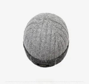Close-up of grey ribbed knit beanie showing thick texture and black brand label detail