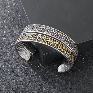 Detailed close-up of Viking compass and Odin runes on a vintage steel bracelet