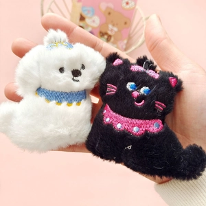 Cute plush animal brooches featuring a white dog and black cat with embroidery details