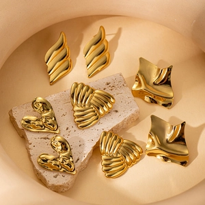 Minimalist gold wavy geometric titanium steel earring set on a stone background
