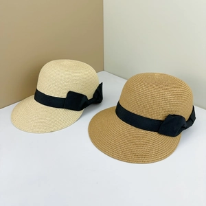Elegant straw sun hats with black ribbon bows in beige and light brown for women