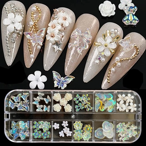 Detailed set of nail art charms with flowers and butterflies in a storage box