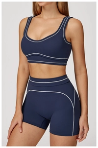 Close-up of contrast stitching detail on high-waist fitness shorts and sports bra set
