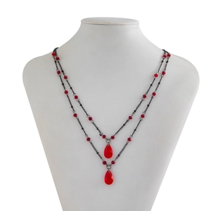 Macro view of double layer gothic necklace with red crystal blood drips and dark metal chain