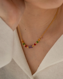 Elegant gold stainless steel necklace featuring a purple rectangle bead and colorful round gems