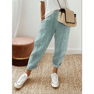Close-up of blue and white striped loose trousers with woven jacquard texture and detail