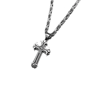 Detailed macro view of Byzantine chain link and dual-tone stainless steel cross pendant