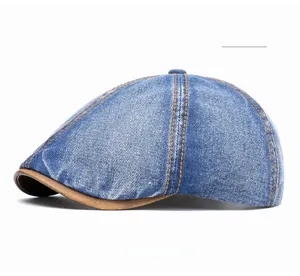 Close-up of vintage blue washed denim ivy cap with contrast stitching and leather brim