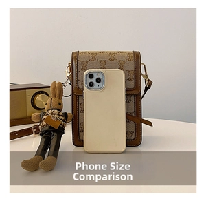 Mini canvas phone bag with brown leather trim and cute bear patterns beside a smartphone