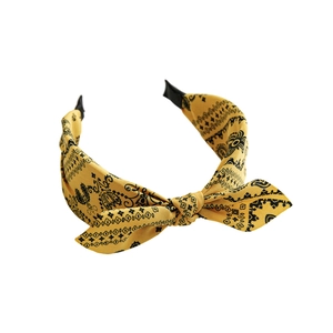Yellow paisley knot headband with ethnic print pattern and wide bow design for women