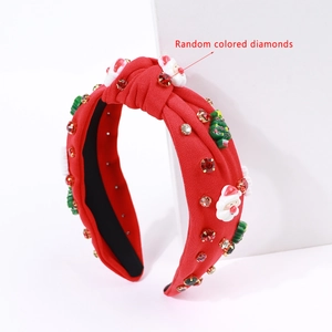 Detail of red knitted Christmas headband with Santa, tree charms and colorful rhinestones