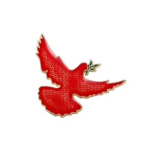 Detailed close-up of a red peace dove brooch with golden edges and olive branch
