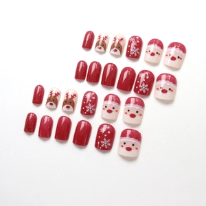 Christmas press-on nails featuring cute reindeer, Santa motifs, and red glitter finish
