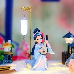 Detailed view of ancient Chinese fairy figurine playing pipa beside a glowing night lantern