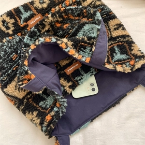 Detailed interior of ethnic fleece tote bag showing purple lining and spacious storage space
