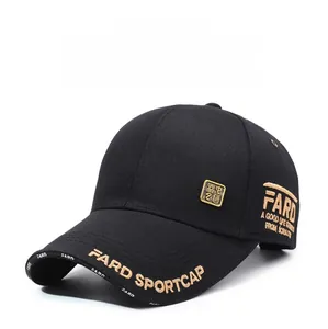Detail of gold embroidery and vintage metal badge on a black cotton baseball cap