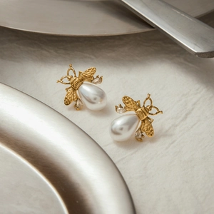 Elegant 18K gold stainless steel bee earrings with white drop pearls and sparkling crystals