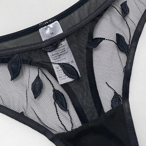 Sheer black mesh thong for women featuring intricate leaf embroidery and breathable fabric