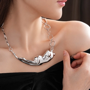 Vue détaillée du collier argenté avec pendentif sculpture abstraite sur un mannequin