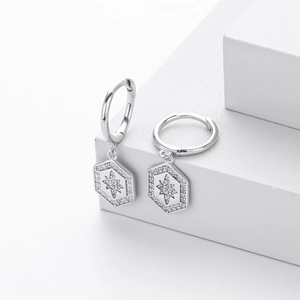 Detail of S925 sterling silver star earrings with micro-set zircon on white geometric steps