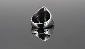 Detailed back view of polished men's titanium steel Eye of Horus ring with embossed sides