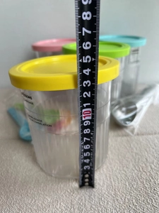 Detail showing Ninja NC501 ice cream pint containers measuring approximately 15cm in height