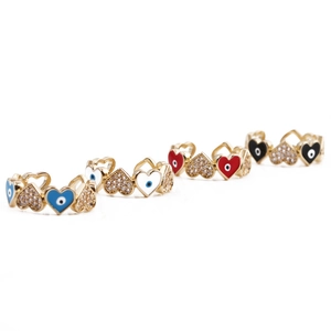 Close-up of four colorful heart rings with blue white red and black enamel in gold plating
