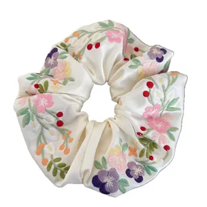 Floral embroidery satin scrunchie with pink and purple flowers on cream silk fabric