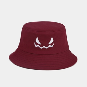 Close-up of monster face embroidery on wine red cotton canvas bucket hat