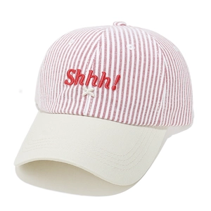 Detail of red striped baseball cap featuring Shhh! 3D embroidery and beige brim