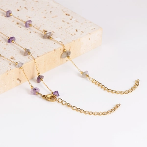 Golden stainless steel necklace featuring irregular purple natural stone beads on stone