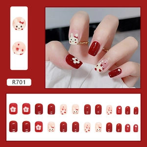 Short red and white press-on nails featuring cute rabbit and floral art designs