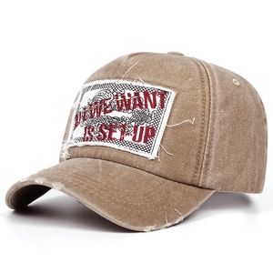 Close-up of vintage washed cotton baseball cap with raw edge embroidery patch detail