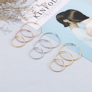 Textured spiral hoop earrings in gold silver and rose gold finishes varied sizes