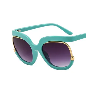 Oversized mint green sunglasses with gradient purple lenses and gold metal accents
