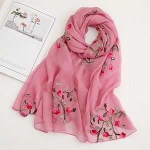 Detailed view of pink floral embroidery on lightweight semi-sheer chiffon beach scarf