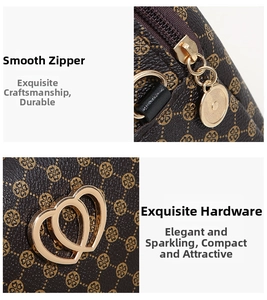 Detail of golden zipper and dual heart-shaped metal logo on brown printed handbag