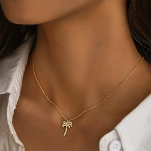Close-up of golden S925 silver necklace featuring a sparkling diamond palm tree pendant
