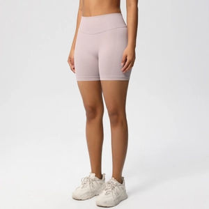 Detailed close-up of wide ribbed waistband on seamless mauve high-waisted yoga shorts